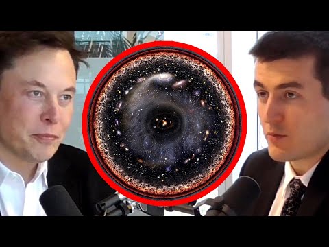 Official still. Elon Musk sits on the right in a dark jacket. Lex Fridman sits on the left. Their card reads: What's outside the simulation?